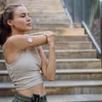 Jeune sportive s'échauffant devant un escalier