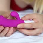 Une femme qui tient un sextoy entre ses mains 