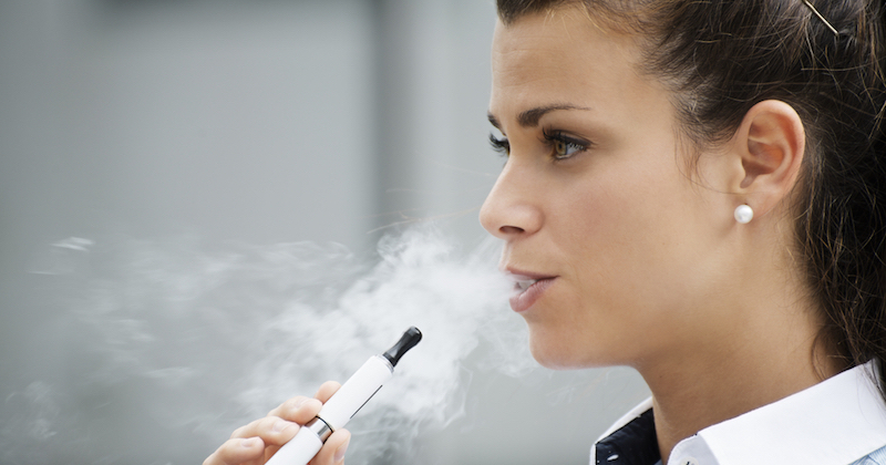 Une femme consomme une cigarette electronique