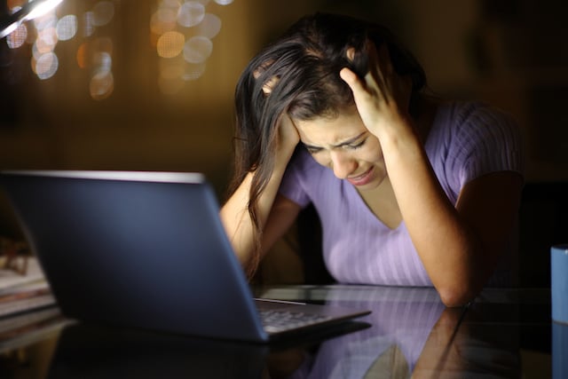 Femme triste devant son ordinateur