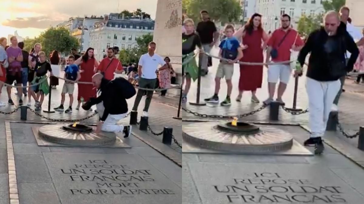 Un homme allumant sa cigarette avec la flamme de la tombe du Soldat inconnu, à Paris