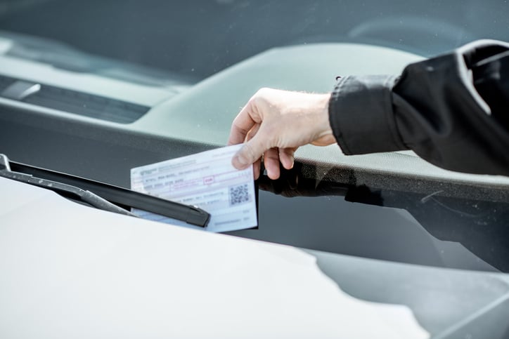 Un policier dépose une amende sur une voiture