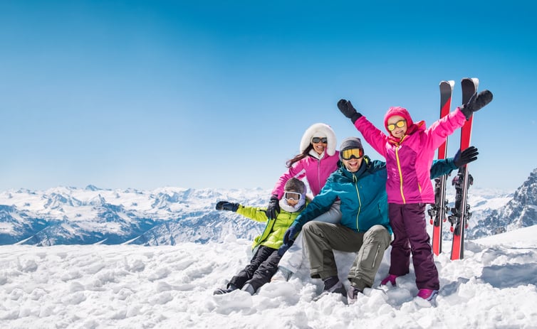 Une famille, en vacances au ski, prend la pause devant l'objectif