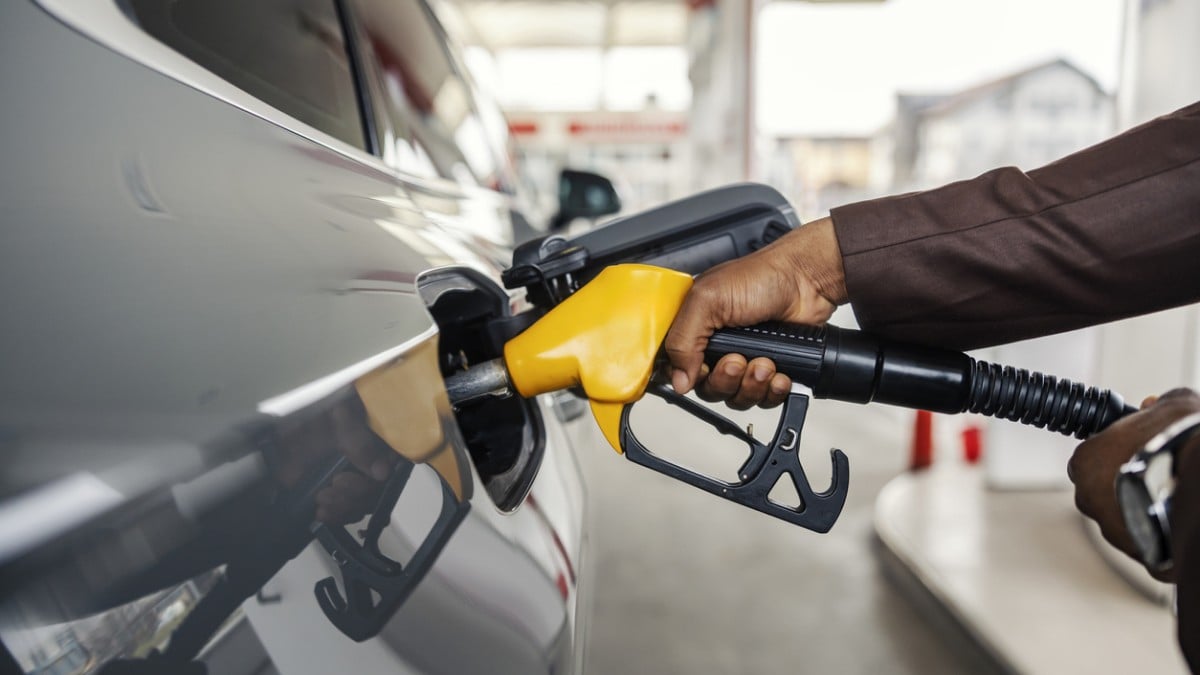 Une personne met de l'essence dans sa voiture