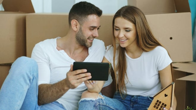 un couple au milieu des cartons de d&eacute;m&eacute;nagement