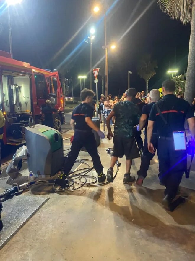 Pompiers intervenant sur une poubelle enterrée